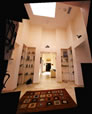 Entrance Hall looking toward Living Room.  The four passageways from this square hall lead to the entrance, dining room, living room, and guest quarters. 